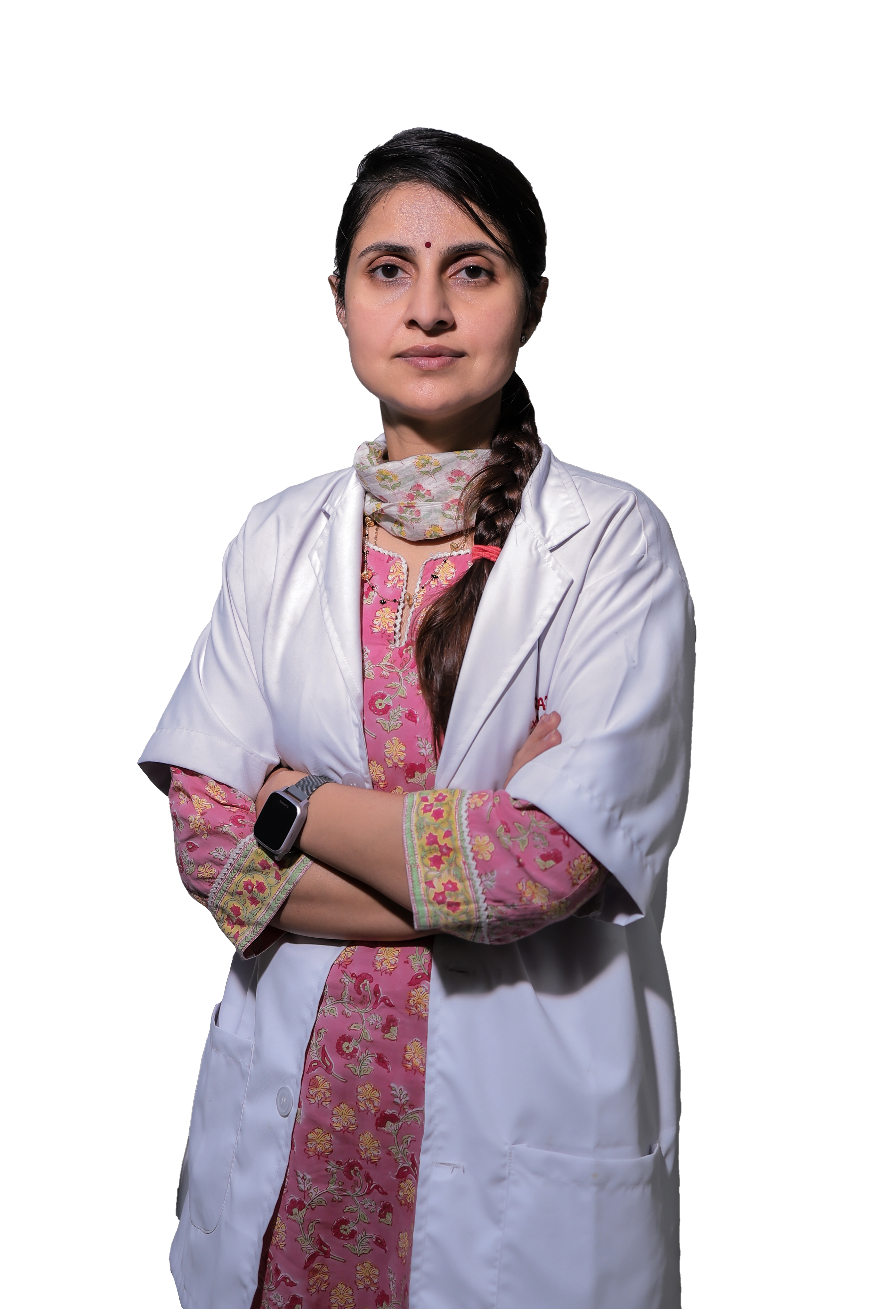 Technician operating the controls of a GE MRI machine with a patient inside.